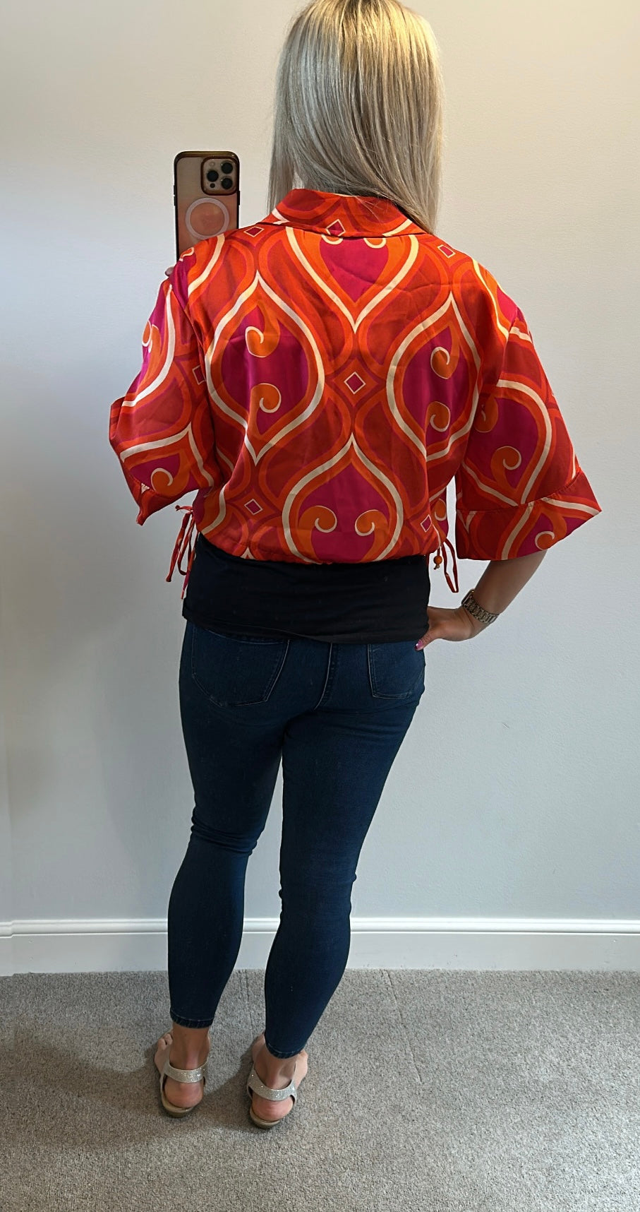 Pink and orange print shirt would fit up to size 12
