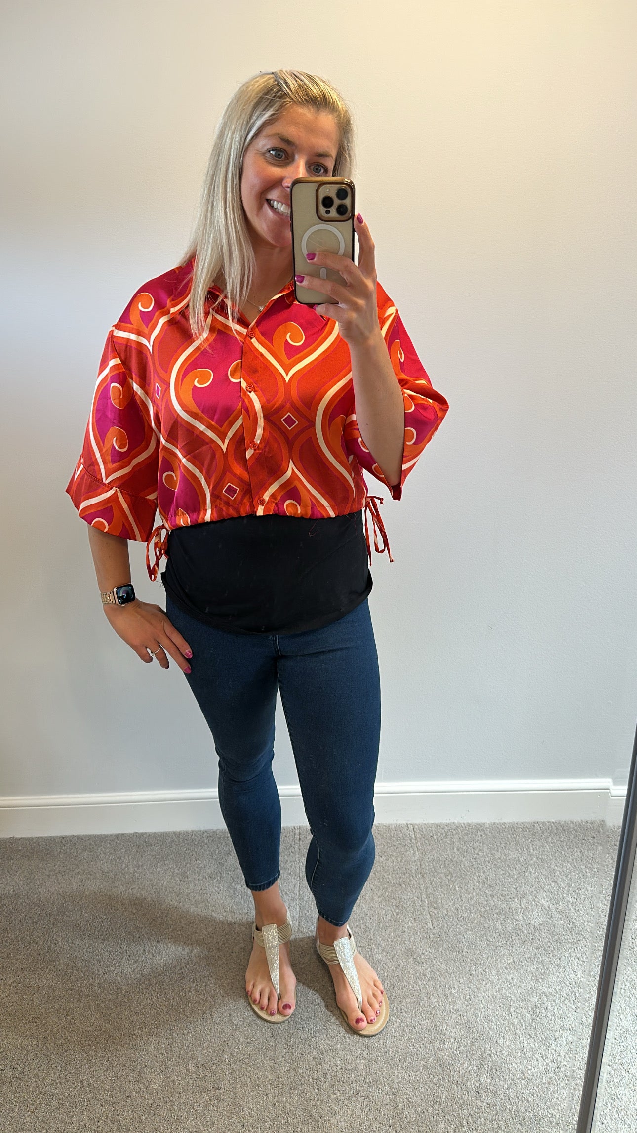 Pink and orange print shirt would fit up to size 12