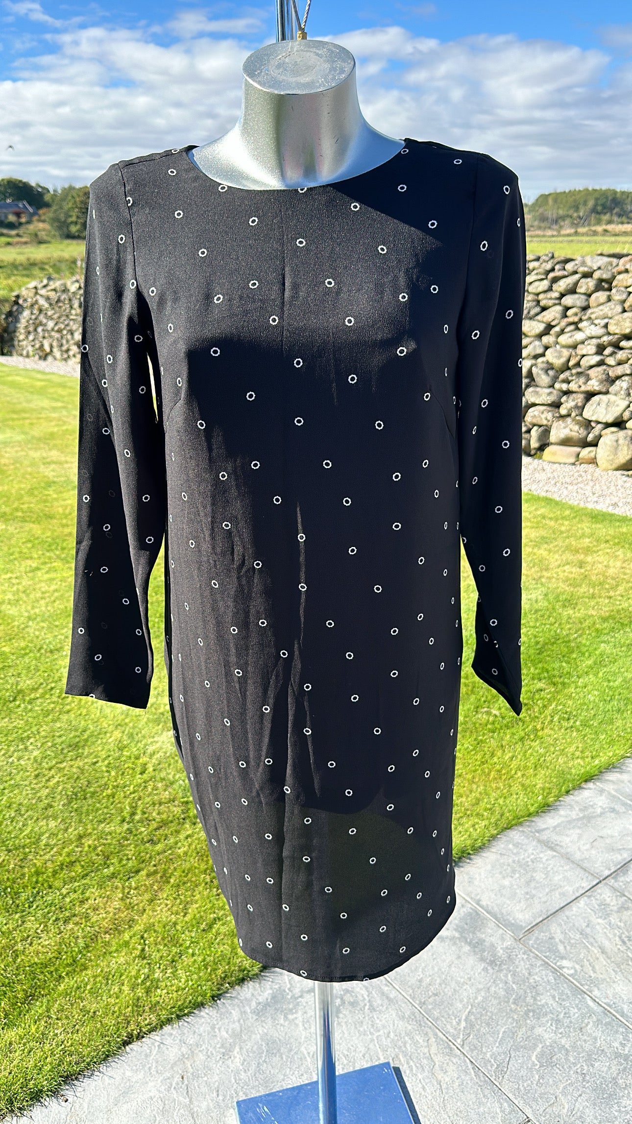 H&M black print dress would fit upto size 10