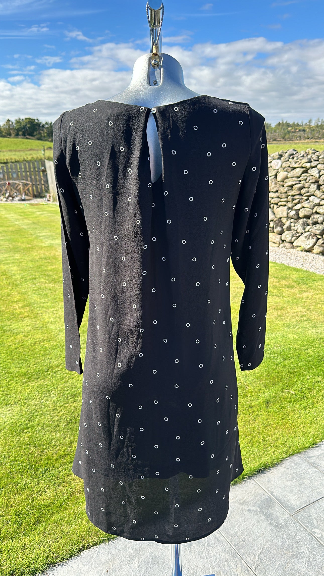 H&M black print dress would fit upto size 10