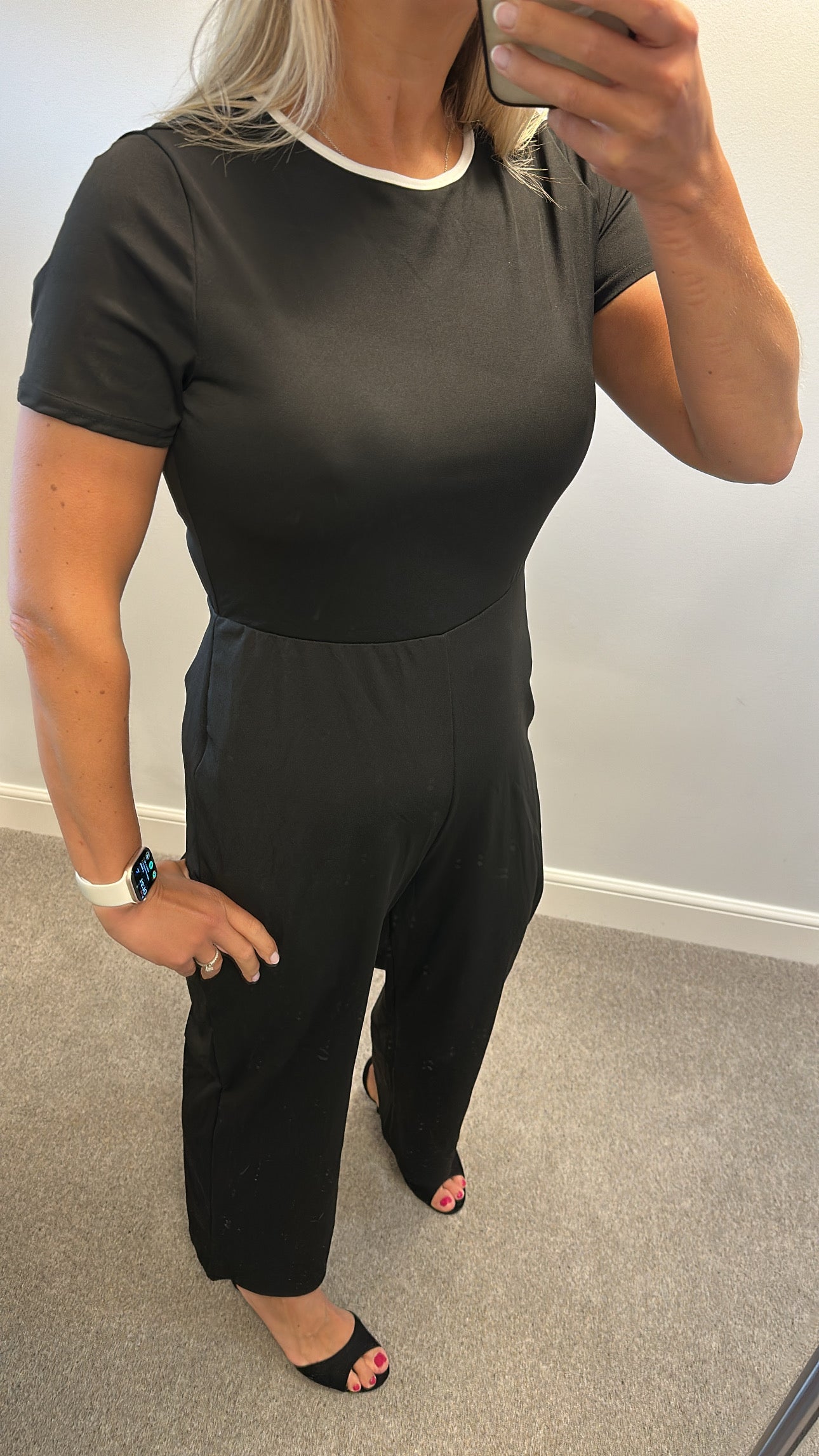 Black jumpsuit with bow detail on back one side would fit upto size 14