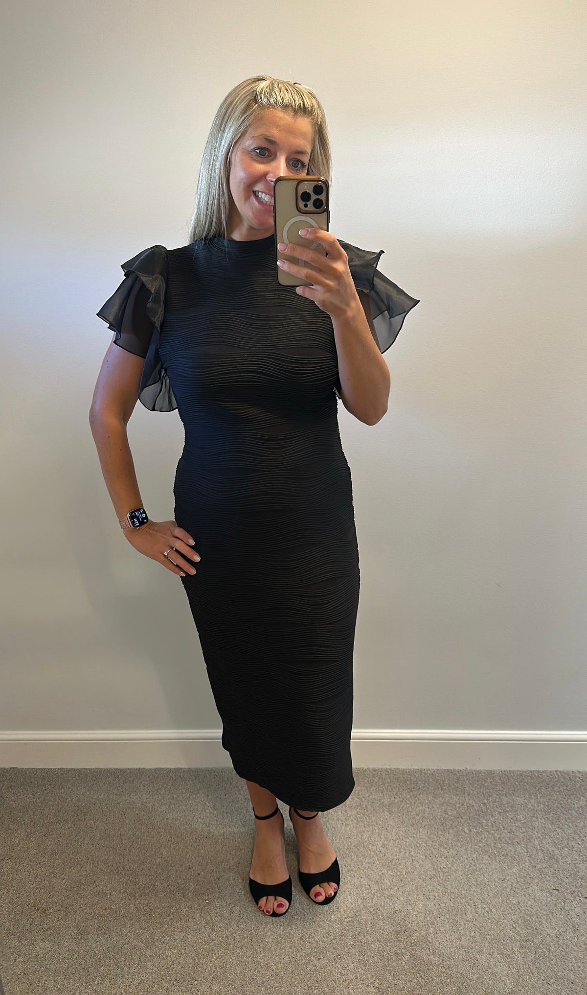 Black ribbed dress with puff sleeves would fit upto size 16