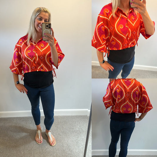 Pink and orange print shirt would fit up to size 12