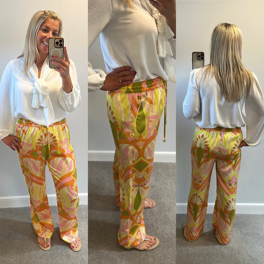 Zara orange print trousers size L would fit upto size 14
