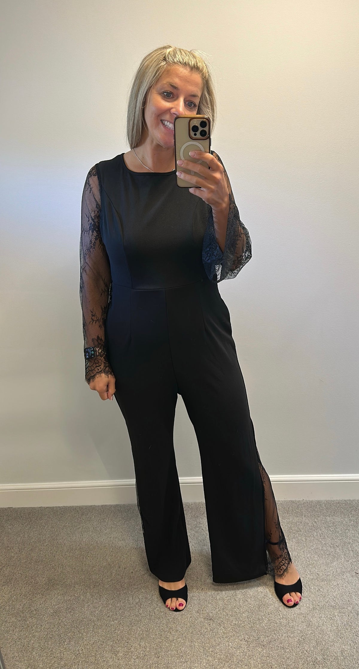Black lace jumpsuit would fit upto size 14