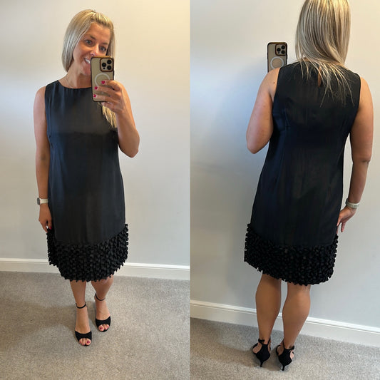 Yera black sleeveless dress with a textured ruffled hemline would fit upto size 14