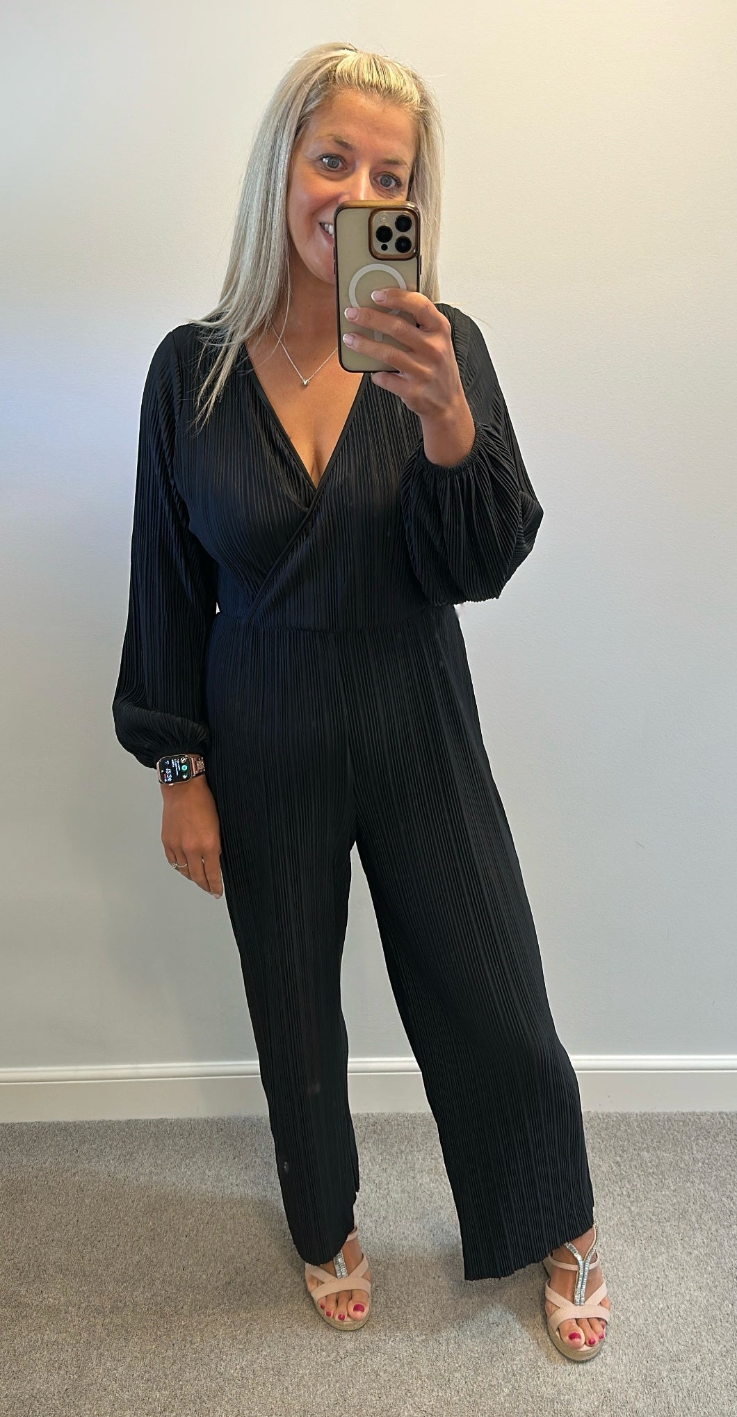 Black pleated jumpsuit would fit upto size 14