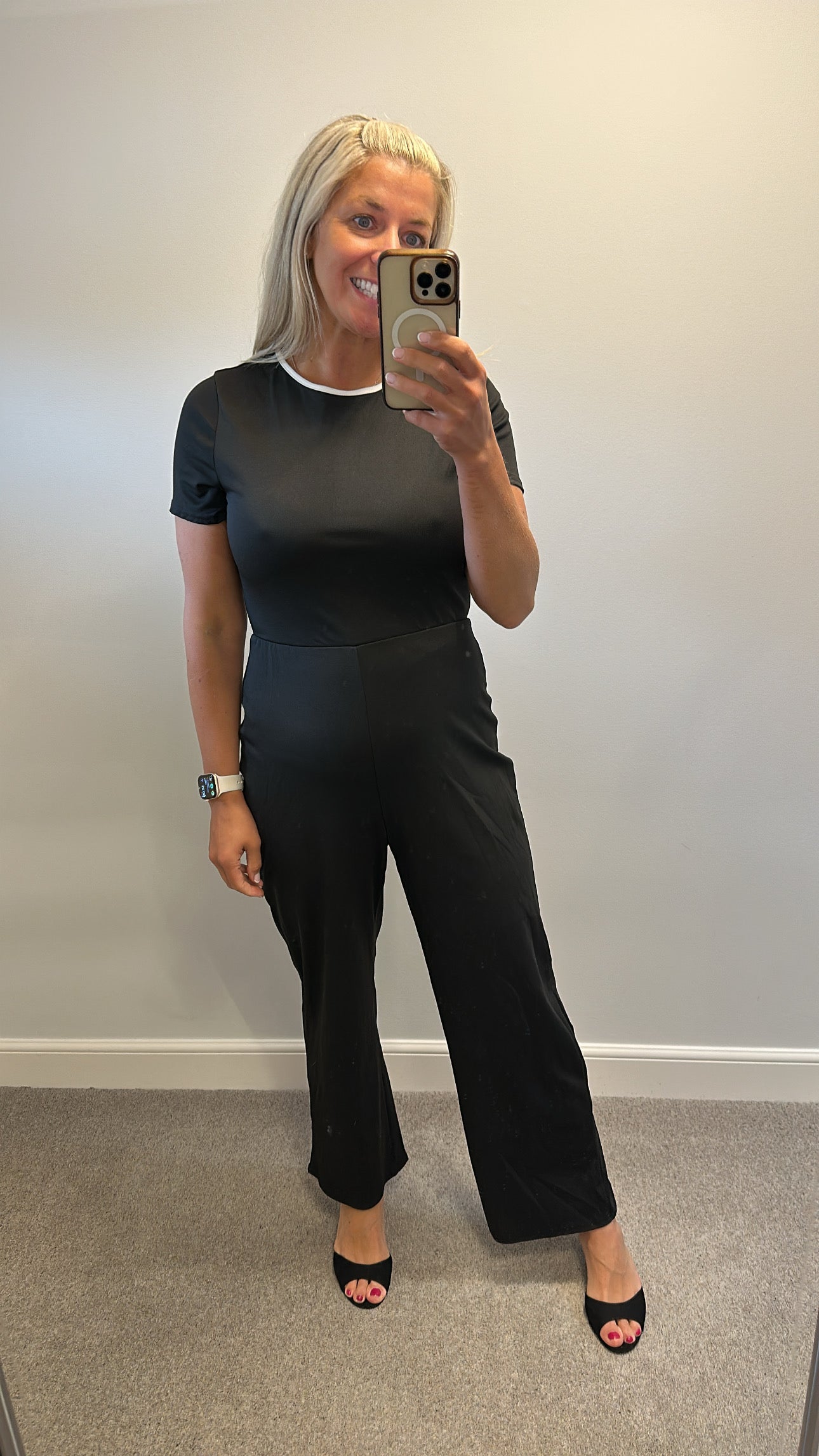 Black jumpsuit with bow detail on back one side would fit upto size 14